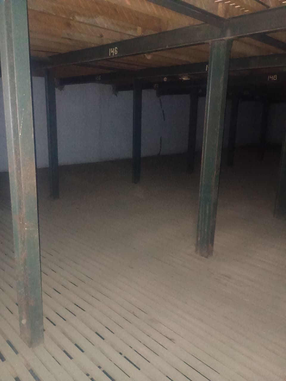 Empty cold storage chamber with numbered steel columns, sections 146–148