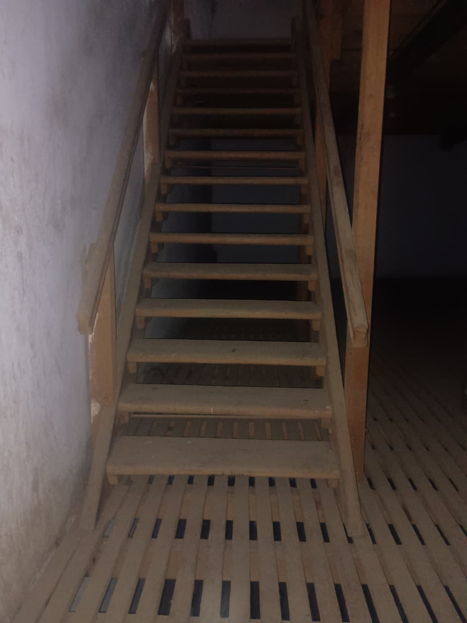 Wooden staircase inside cold storage facility connecting floors